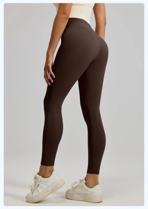Close-up of chocolate brown yoga leggings featuring high-waisted cut and peach butt lifting line