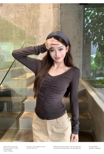 Close-up of ruched front detail on coffee brown slim fit long sleeve v-neck top