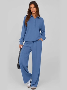 Detail of smog blue polo collar top with buttons and high waist wide leg trousers