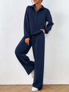 Detail view of the button-down polo collar and textured fabric on this navy tracksuit