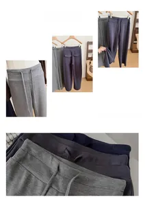 Dettaglio dei pantaloni sportivi a vita alta con coulisse in grigio e blu navy