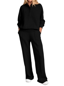 Detail of black long-sleeve polo top and high-waist wide-leg trousers set for women