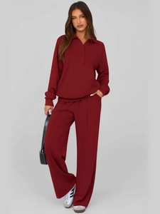 Detail of burgundy two-piece loungewear set featuring a polo collar and wide leg trousers