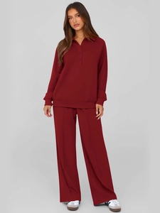 Close-up of wine red two-piece tracksuit featuring button-up sweatshirt and wide-leg trousers