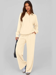 Detail of beige two-piece knit set featuring polo neck sweater and wide-leg trousers