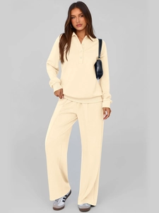 Detail of knitted polo neck long sleeve top and wide-leg trousers in beige cream set