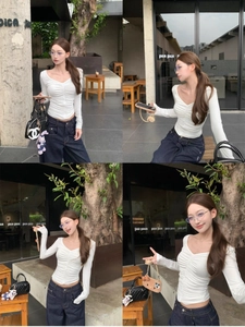 Slim fit white V-neck long sleeve top with ruched detailing and outdoor lifestyle styling