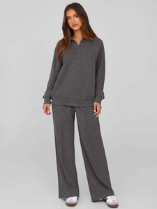 Detail of dark grey two-piece set featuring long-sleeve polo sweatshirt and wide-leg pants