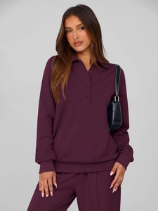 Detailed macro view of dark plum long sleeve polo sweatshirt and matching joggers set