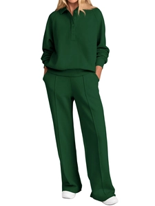Close-up of dark green polo neck top and wide-leg pants with front pleat detail