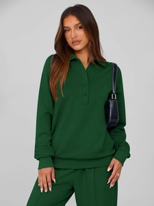 Detail of dark green two-piece tracksuit featuring polo collar sweatshirt and matching pants