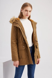 Close-up of khaki winter parka with faux fur hood, waist drawstring and fleece lining