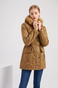 Detail of winter parka featuring thick faux fur trimmed hood and adjustable drawstring waist