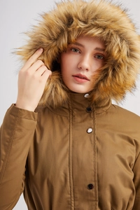 Close-up of winter parka with thick faux fur hood and high windproof collar with metal snaps