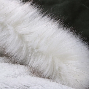 Détail de parka verte montrant le col en fourrure blanche et la texture de la doublure