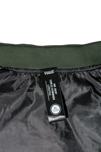 Close-up of MA1 bomber jacket inner lining with woven brand label and size tag