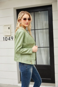 Detail of light green PU leather jacket showing the zipper pocket and moto biker style
