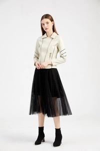 Detail of a beige PU leather biker jacket with black sleeve stripes and sequin mesh skirt