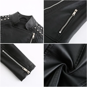 Detail view of black faux leather jacket with metal zippers, studs and PU texture