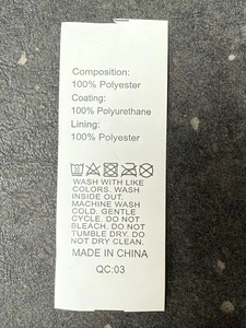 Detailed care label showing 100% polyester material composition and washing instructions