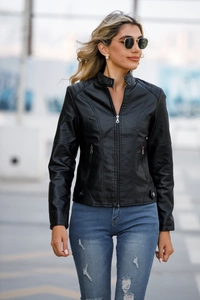 Close-up of black faux leather biker jacket with stand collar and quilted sleeve details