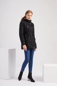 Fashion model wearing a black hooded parka with adjustable drawstring waist and cargo pockets