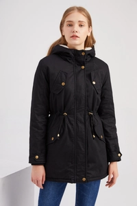 Detail of a black parka with gold metal buttons, drawstring waist and white faux fur lining