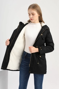 Detail view of black parka with white fleece lining and adjustable drawstring waist