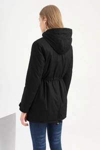 Rear view of women's black hooded parka jacket featuring adjustable drawstring waist detail