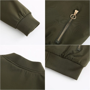 Detail view of olive green jacket featuring ribbed cuffs and gold circular zipper pulls