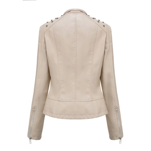 Detail view of silver rivets on the back shoulders of a beige faux leather jacket