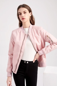 Detail of pink bomber jacket with sleeve zipper pocket and ribbed cuffs on white backdrop