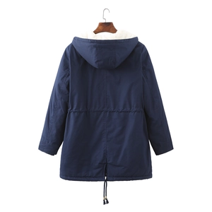 Detail view of navy parka featuring warm white fleece lining and adjustable waist drawstring