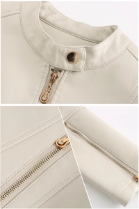 Detail of cream faux leather jacket showing stand collar and ornate gold zipper puller