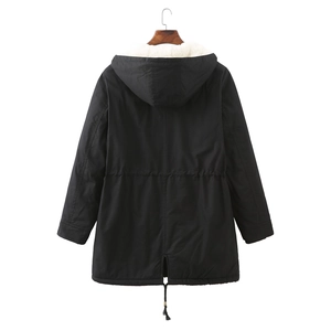 Detail view of women's black parka featuring white faux lamb wool lining and drawstring waist