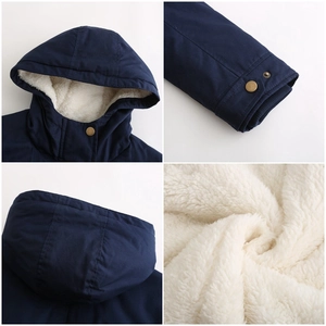 Detailed view of fleece lining, hooded collar and ribbed cuffs on navy winter parka