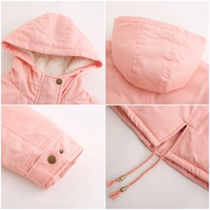 Detail of light pink winter parka with plush lining, drawstring hood, and metal snap cuffs