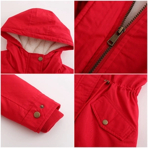 Detail view of red winter parka showing hooded collar, metal zipper, and fleece lining