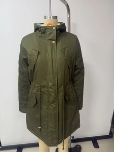 Detail view of military green parka coat featuring plush lamb wool lining and drawstring waist