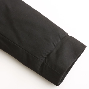 Detailed close-up of the black parka coat sleeve cuff with high-density stitching