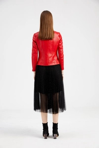 Back view of a red short faux leather jacket paired with a black pleated tulle skirt