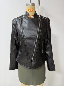 Detail showing silver rivet studs and metallic zippers on the black biker leather jacket