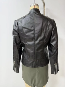 Detail of silver rivets on shoulders and metal zippers on black biker jacket sleeves