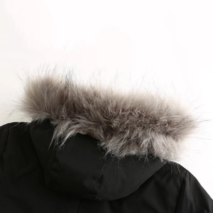 Close-up of thick faux fur hood trim on black winter parka with windproof fabric