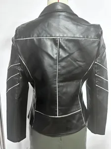 Detail of black PU leather biker jacket featuring white contrast piping on back and sleeves