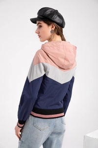 Detail view of pink grey navy color block hooded windbreaker with elastic hem and cuffs