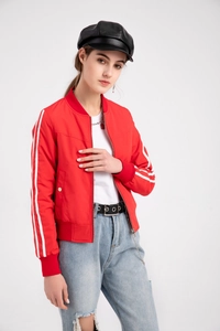 Detail of red women's bomber jacket featuring white double-striped sleeves and zip closure