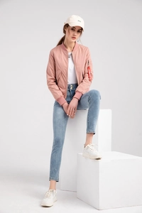 Pink pilot bomber jacket featuring a classic utility sleeve pocket and a red zipper tag