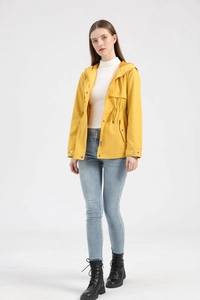 Full body view of yellow hooded windbreaker with drawstring waist and cargo pockets