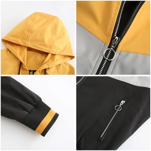 Macro view of drawstring hood, ribbed cuffs, and zipper detail of hooded colorblock jacket
